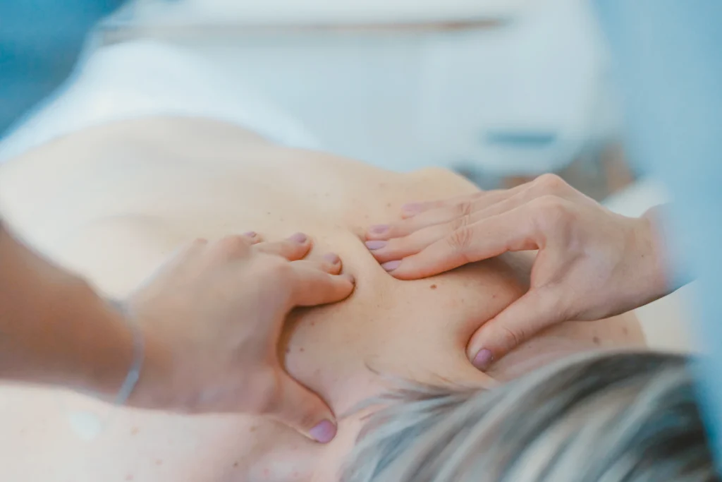 Thai massage therapist working on a client's back in Claremont